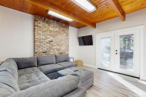 a living room with a couch and a brick wall at Speckled Tahoe in Kings Beach