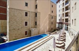 a swimming pool in the middle of a building at Becici Chic 1BR Condo swimming pool long term in Budva