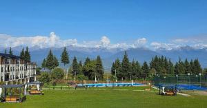 a view of a soccer field with mountains in the background at TelaValley Residence in Shalauri