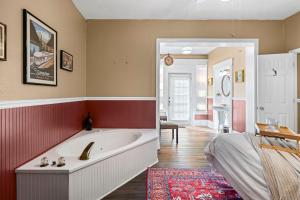 a large bathroom with a tub and a bedroom at Southern Wind Inn in St. Augustine +116 photos