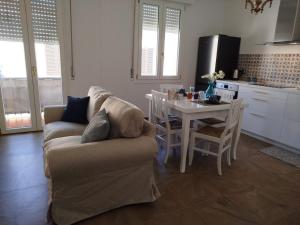 a living room with a couch and a table at Turquoise Horizon in Stintino