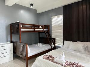 a bedroom with two bunk beds and a desk at Dajon#4-Barkada Generator & starlink in General Luna +3 photos