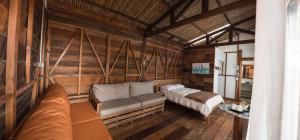 a living room with a couch and a bed at Montana Posada in Roldanillo