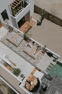 an overhead view of a house with a table and an umbrella at CasaBlancoMadera in Todos Santos