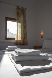 a group of towels sitting on top of a bed at Villa Marlene in Astris +25 photos