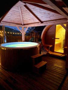 a large hot tub on a deck with a roof at KLOBUCKÉ RETRO bydlení a wellness in Valašské Klobouky