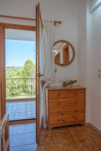 a bathroom with a dresser and a mirror and a balcony at Villa Marlene in Astris