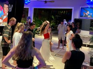 a bride and groom on a dance floor with people at Casa Mexico Lindo - Boutique Hostel in Bacalar +44 photos
