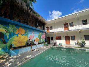 a mural on the side of a building next to a swimming pool at Casa Mexico Lindo - Boutique Hostel in Bacalar