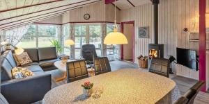 a living room with a table and a couch at VE040-Vejers-Strand-Jafdalvej-5 in Vejers Strand