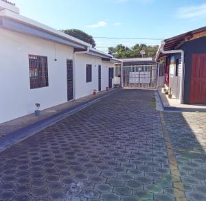 a cobblestone street in front of two white buildings at Volcano Hostal in Rivas