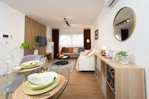 a living room with a table with plates on it at Secret Garden Apartman in Varaždin