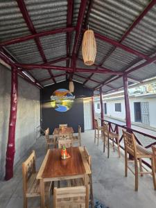 a dining room with wooden tables and chairs at Volcano Hostal in Rivas