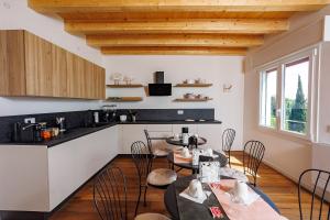 a kitchen and dining room with tables and chairs at Il Sentiero di Arquà in Arquà Petrarca