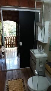 a bathroom with a toilet and a glass shower at Bosque da Lua - Suite with 2 bathrooms - Up to 5 guests in Itupeva