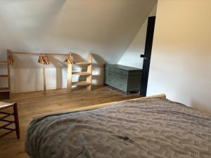 a bedroom with a bed and a desk and a chair at Irene 2 in Hindeloopen