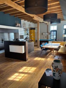 a kitchen and living room with a table and a dining room at Irene 2 in Hindeloopen