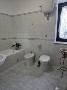 a bathroom with a toilet and a bidet and a sink at Domus Anemone B&B in Avellino +6 photos