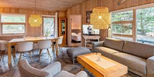 a living room with a couch and a table at VE125-Vejers-Strand-Aavej-19 in Vejers Strand