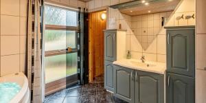 a bathroom with a tub and a sink and a toilet at VE125-Vejers-Strand-Aavej-19 in Vejers Strand +29 photos