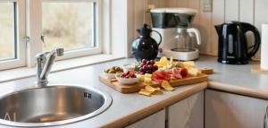 a kitchen counter with a plate of food on a cutting board at VE147-Vejers-Strand-Violvej-16 in Vejers Strand