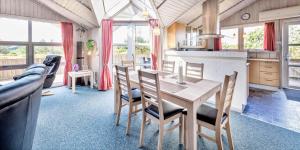 a kitchen and dining room with a table and chairs at VE047-Vejers-Strand-Jafdalvej-91 in Vejers Strand