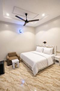 a bedroom with a bed and a ceiling fan at The Whale Inn Narayi rd Barnawa high cost in Kaduna