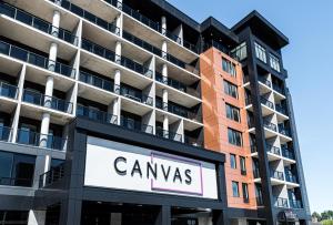 a sign in front of a tall building at Canvas Moncton, Tapestry Collection By Hilton in Moncton
