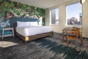 a bedroom with a bed and a chair and a desk at Canvas Moncton, Tapestry Collection By Hilton in Moncton +26 photos
