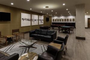 a lobby with couches and tables and a piano at Estancia del Norte San Antonio, A Tapestry Hotel by Hilton in San Antonio