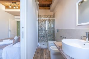 a bathroom with a sink and a toilet and a shower at B&B della stazione in Pachino +87 photos