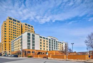 a large yellow and white building on a city street at DoubleTree by Hilton Davenport in Davenport