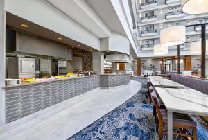 a restaurant with a buffet in a building at DoubleTree by Hilton Davenport in Davenport