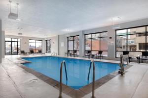 a large swimming pool in a building with windows at DoubleTree by Hilton Davenport in Davenport