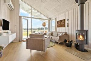 a living room with a couch and a fireplace at 8529-Grenaa-Strandsletten-61 in Grenå