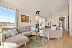 a living room with a couch and a table at 8529-Grenaa-Strandsletten-61 in Grenå
