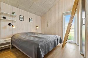 a bedroom with a bed and a ladder in it at 8529-Grenaa-Strandsletten-61 in Grenå