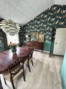 a dining room with a table and chairs and a patriotic wall at AE325-Marstal-Skovgyden-32 in Marstal +5 photos