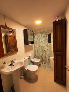 a bathroom with a sink and a toilet and a shower at Paseo del mar in Melilla +9 photos