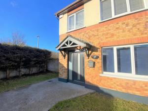 a brick house with an awning over the door at Dublin Cosy Home in Dublin