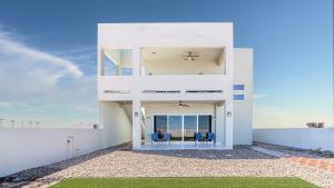 a white house with a view of the ocean at Casa Bonita Encantame Estates in Playa Encanto