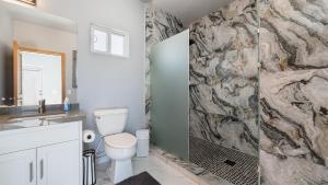 a bathroom with a sink and a toilet and a shower at Casa Bonita Encantame Estates in Playa Encanto +17 photos