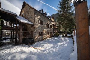 a building with snow in front of it at Arties Lodge in Arties