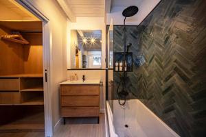a bathroom with a bath tub and a sink at Arties Lodge in Arties +79 photos