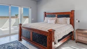 a bedroom with a wooden bed and a balcony at Casa Bonita Encantame Estates in Playa Encanto