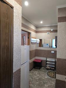 a kitchen with a white refrigerator and a counter at Апарт Отель Элин in Svalyava