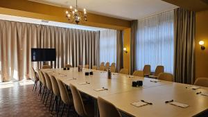 a conference room with a long table and chairs at Hotel de Korenwolf in Gulpen