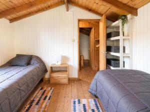 a bedroom with a bed and a book shelf at Cabañas Chucao 2 in San Martín de los Andes