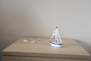 a small toy boat sitting on top of a table at B&B Le Grazie Tropea in Tropea