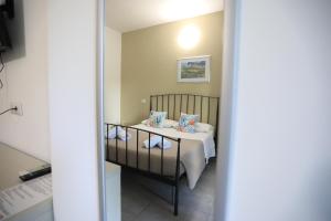 a room with a bed and a table with pillows at B&B Le Grazie Tropea in Tropea